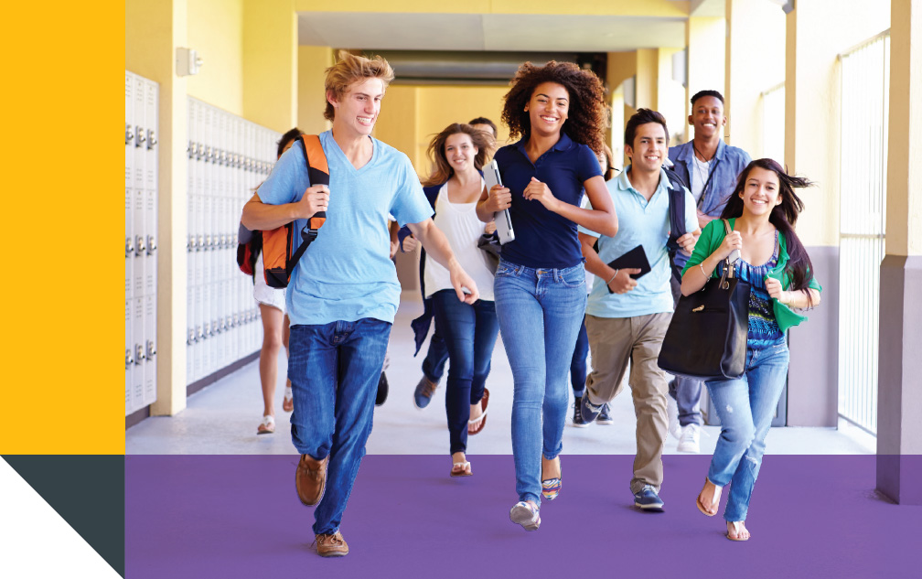 Students running through school hallway